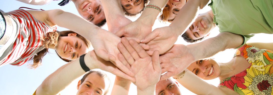 People in circle with hands on each other